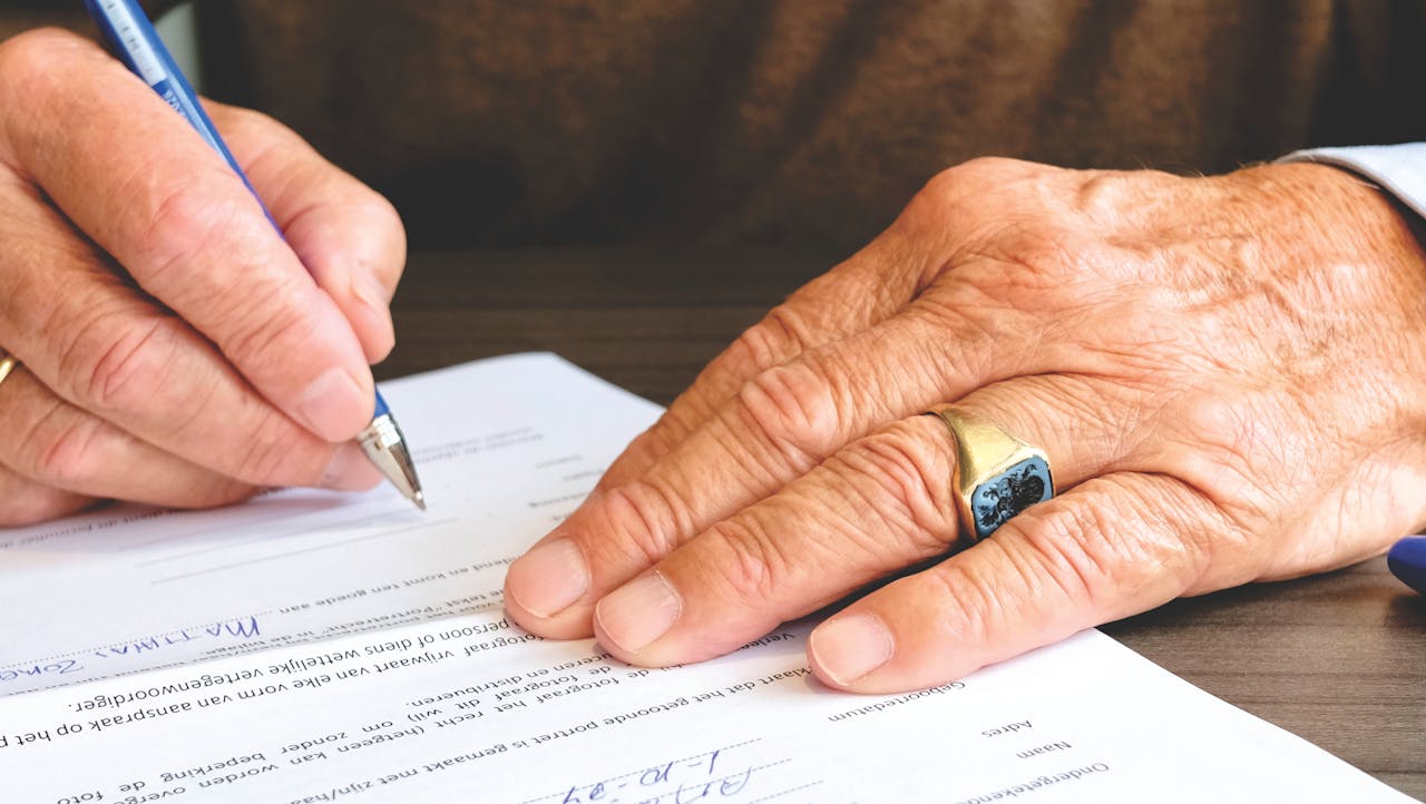 man writing a bankruptcy petition